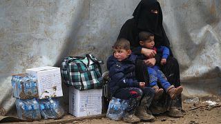Image: Civilians from Mosul wait after arriving in a camp