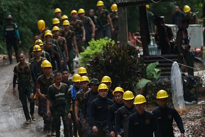 Military personnel walk in line as they prepare to enter the Tham Luang cave complex, where 12 boys and their soccer coach are trapped, in the northern province of Chiang Rai, Thailand on July 6, 2018.