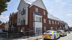 Image: Police officers stand guard at a residential house in Amesbury