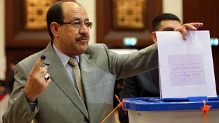 Image: Iraqi Prime Minister Nouri al-Maliki shows his ink-stained finger as