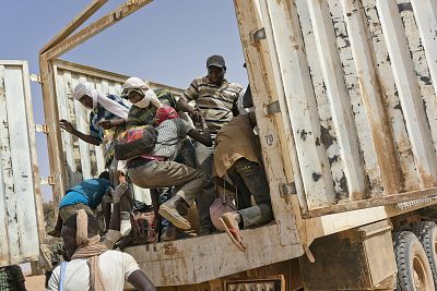 Migrants climb into a truck to head north into Algeria at the Assamaka border post in northern Niger on Sunday, June 3, 2018.