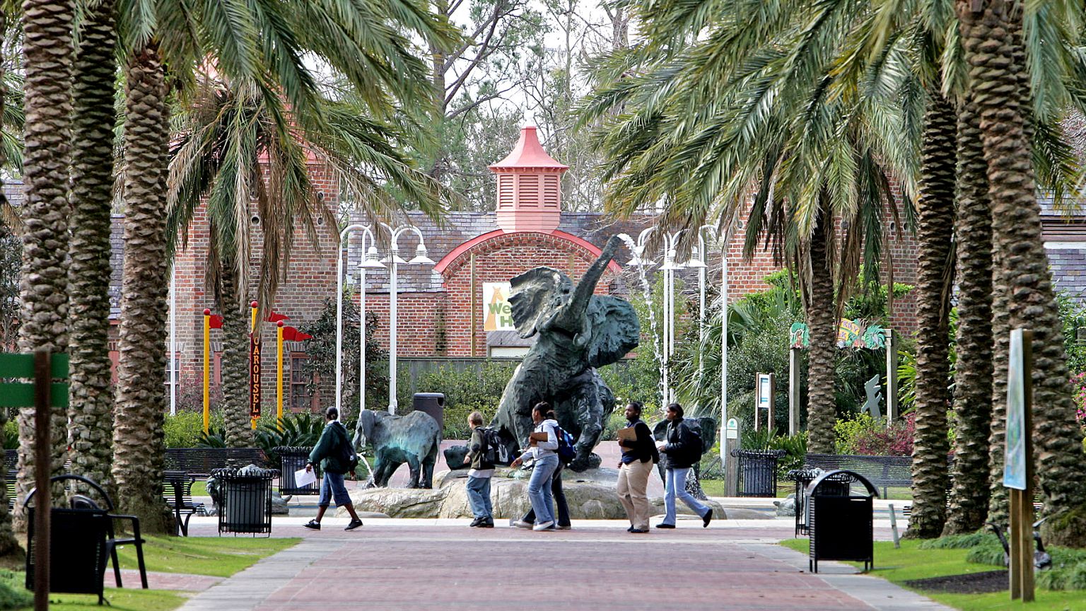 Image: People walk past a bronze elephant on the grounds of the Audubon Zoo