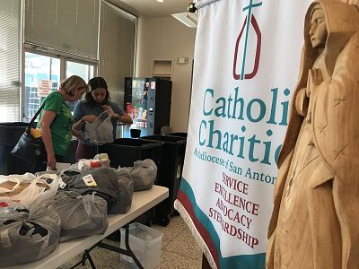 Volunteers at Catholic Charities San Antonio assist families that were separated at the border with clothing, food and temporary housing assistance before they move on to other parts of Texas or the country.