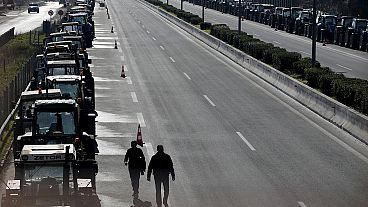 Greek farmers block Athens airport road junction with tractors