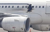 Passenger jet lands safely after hole blown in fuselage