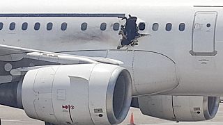 Passenger jet lands safely after hole blown in fuselage