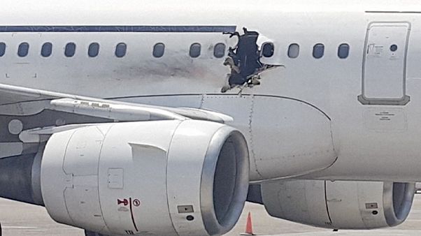 Passenger jet lands safely after hole blown in fuselage Passenger jet lands safely after hole blown in fuselage