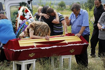 Relatives grieve at the coffin of pro-Russian fighter Dmitri Bystriukov, who was killed during a mortar attack, in the city of Krasnodon, eastern Ukraine, on Thursday.