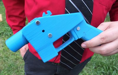 Software engineer Travis Lerol takes aim with an unloaded Liberator handgun in the backyard of his home on July 11, 2013. The Liberator was the first gun that could be made entirely with parts from a 3D printer and computer-aided design (CAD) files downloaded from the Internet.