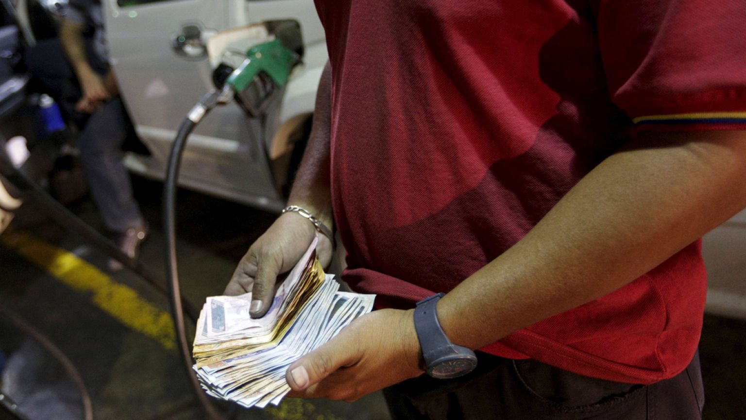As oil prices slide, Venezuela raises fuel prices by up to 6,000%, devalues currency