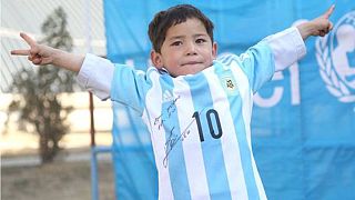 Afghan 'plastic bag Messi' gets to join his idol on the pitch