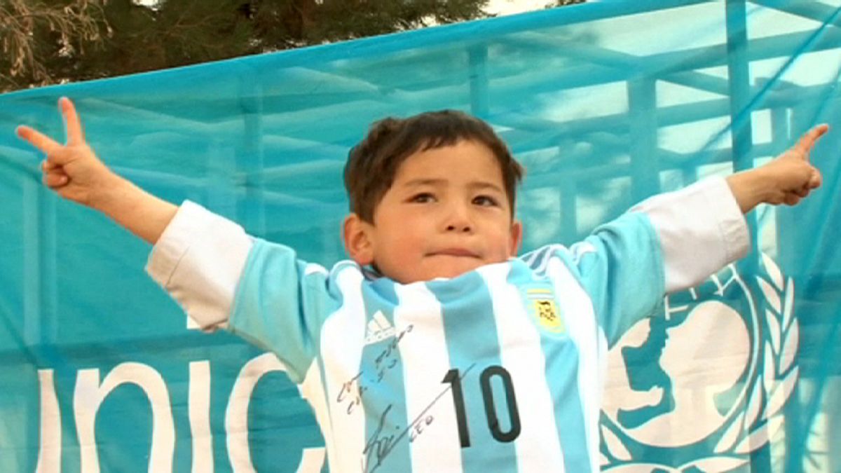 {Watch} From plastic bag to the real thing: Messi delights Afghan boy with signed jersey