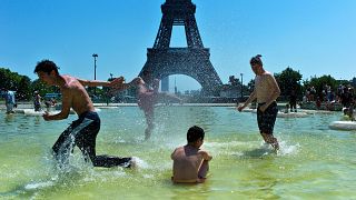 Image: Boys play in a fountain near the Eiffel Tower