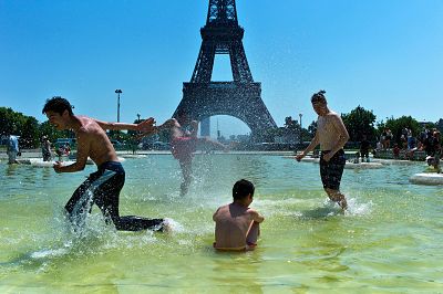 Boys play in a fountain near the Eiffel Tower in Paris.