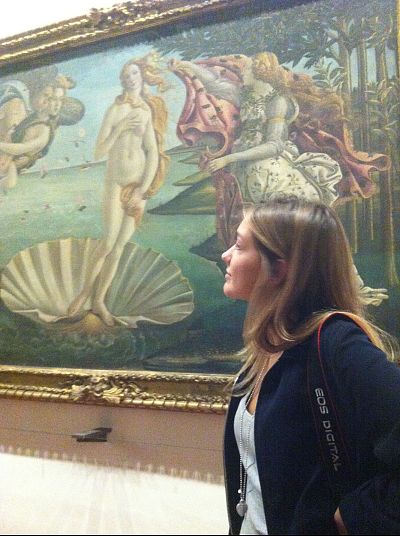 Simonetta Cattaneo next to "The Birth of Venus" painting at the Uffizi Gallery in Florence, Italy.
