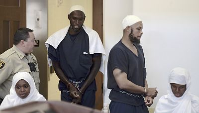 Defendants, from left, Hujrah Wahhaj, Lucas Morton, Siraj Wahhaj and Subbannah Wahhaj enter district court in Taos, N.M., for a detention hearing, on Aug. 13, 2018.