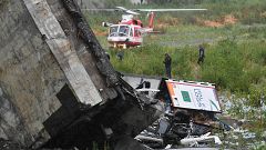 Image: Rescuers scour the debris after the bridge collapsed
