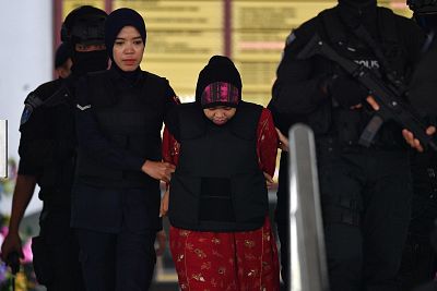 Indonesian national Siti Aisyah is escorted by Malaysian police after a hearing at the Shah Alam High Court, outside Kuala Lumpur on Aug. 16, 2018.