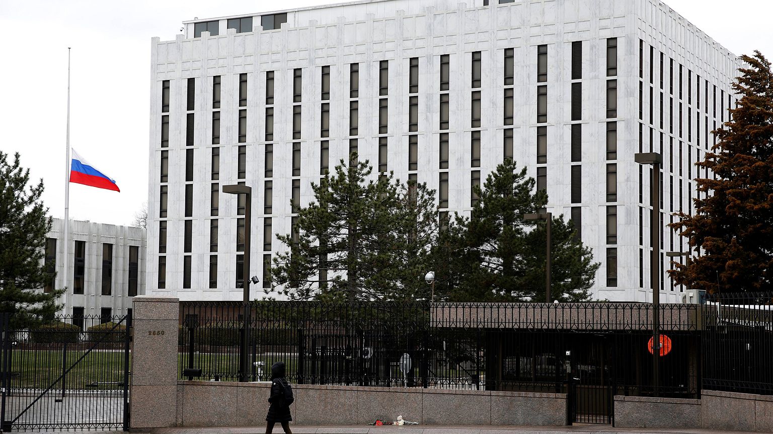 Image: A pedestrian walks past the Russian Embassy in Washington