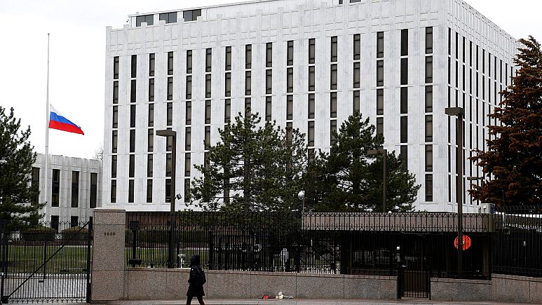 Image: A pedestrian walks past the Russian Embassy in Washington