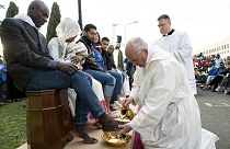 Pope Francis washes feet of refugees, condemns Brussels attacks