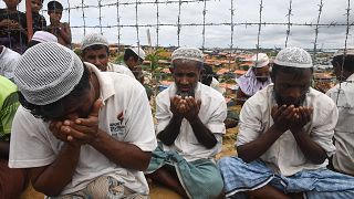 Rohingya refugees perform prayers as they attend a ceremony organised to re