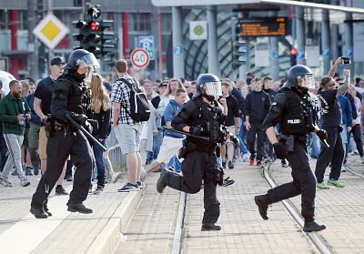 Riot police cross the street in Chemnitz after the death of a 35-year-old German triggered demonstrations and violence Sunday. 