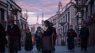 Image: Pilgrims walking and praying near the Jokhang Temple