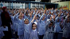Image: Palestinian schoolgirls participate in the morning exercise at an UN
