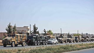 Image: Turkish forces move in a convoy in Syria's Idlib province
