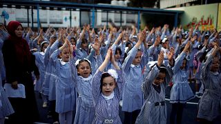 Image: Palestinian schoolgirls participate in the morning exercise at an UN