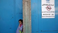 Image: A girl stands at the entrance of a school run UNRWA in the West Bank