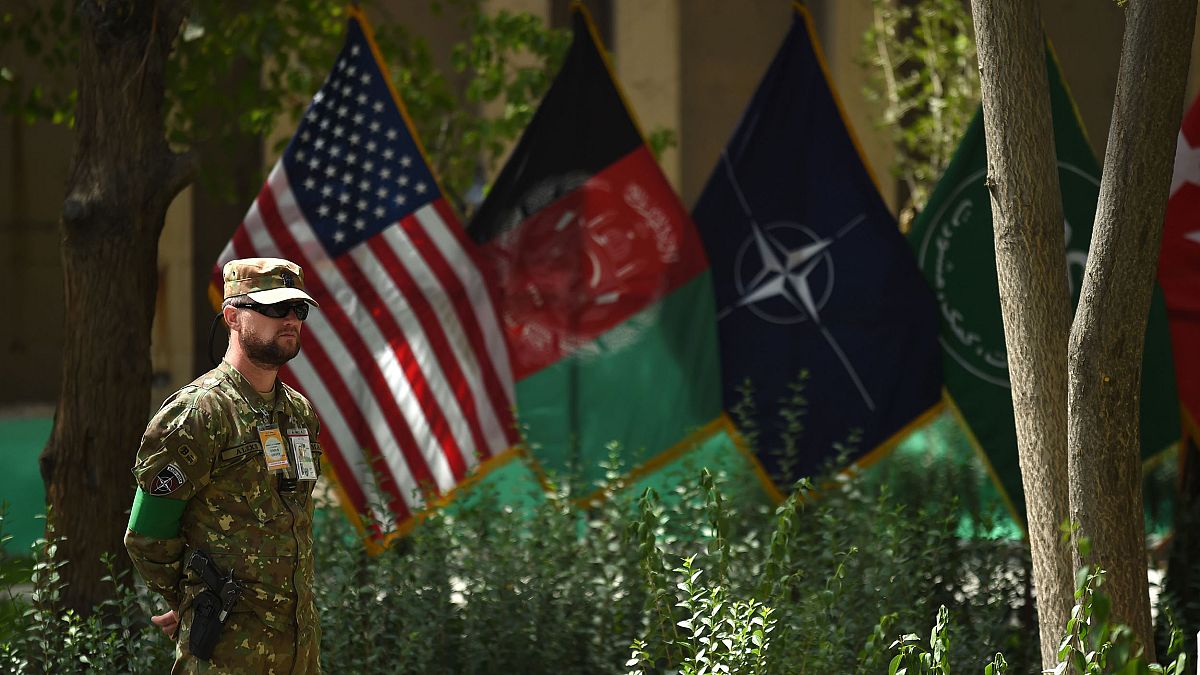 Image: An U.S. military personnel stands during a change of command ceremon