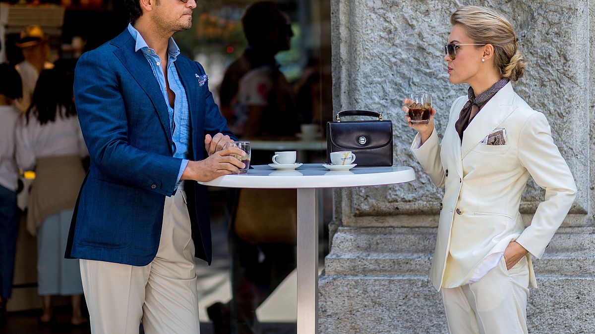 Image: A couple drink Italian coffee outside Jil Sander during the Milan Me