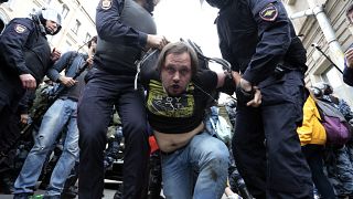 Image: A protester is detained in St. Petersburg, Russia