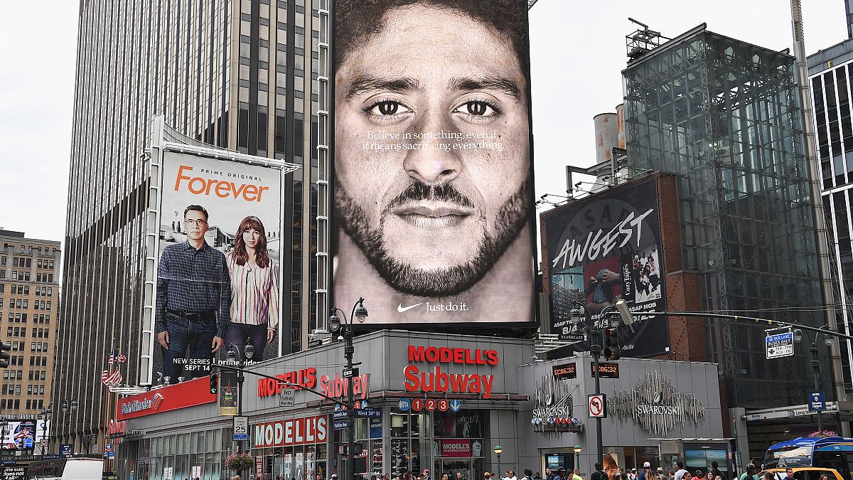 Image: A Nike ad featuring Colin Kaepernick is on display on top of a Model
