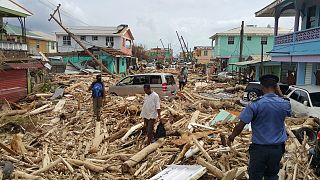 Resident survey damage from Hurricane Maria in Roseau, Dominica, on Sept. 2