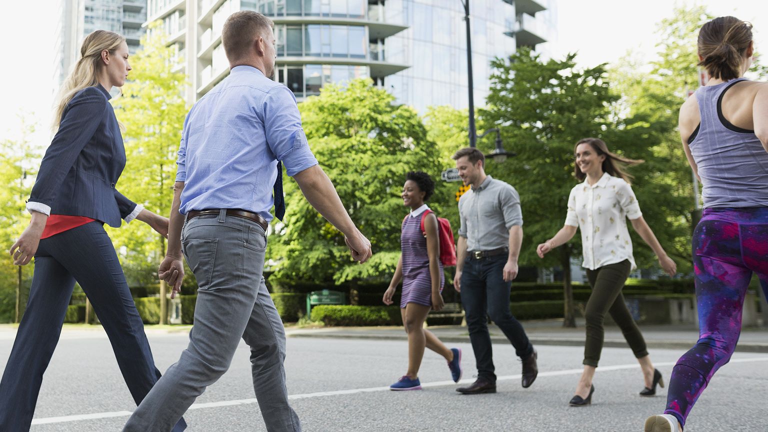 People cross a busy street