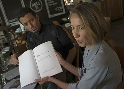 Ricardo Mendes, left, and Oane Bijlsma, two of four alleged victims of sexual, physical and psychological abuse show the report titled they presented the Dalai Lama.