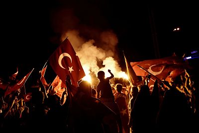 Pro-Erdogan supporters wave Turkish national flags during a rally in Istanbul on July 18, 2016, a few days after the failed coup attempt.