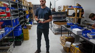 Image: Cody Wilson, owner of Defense Distributed company, holds a 3D printe