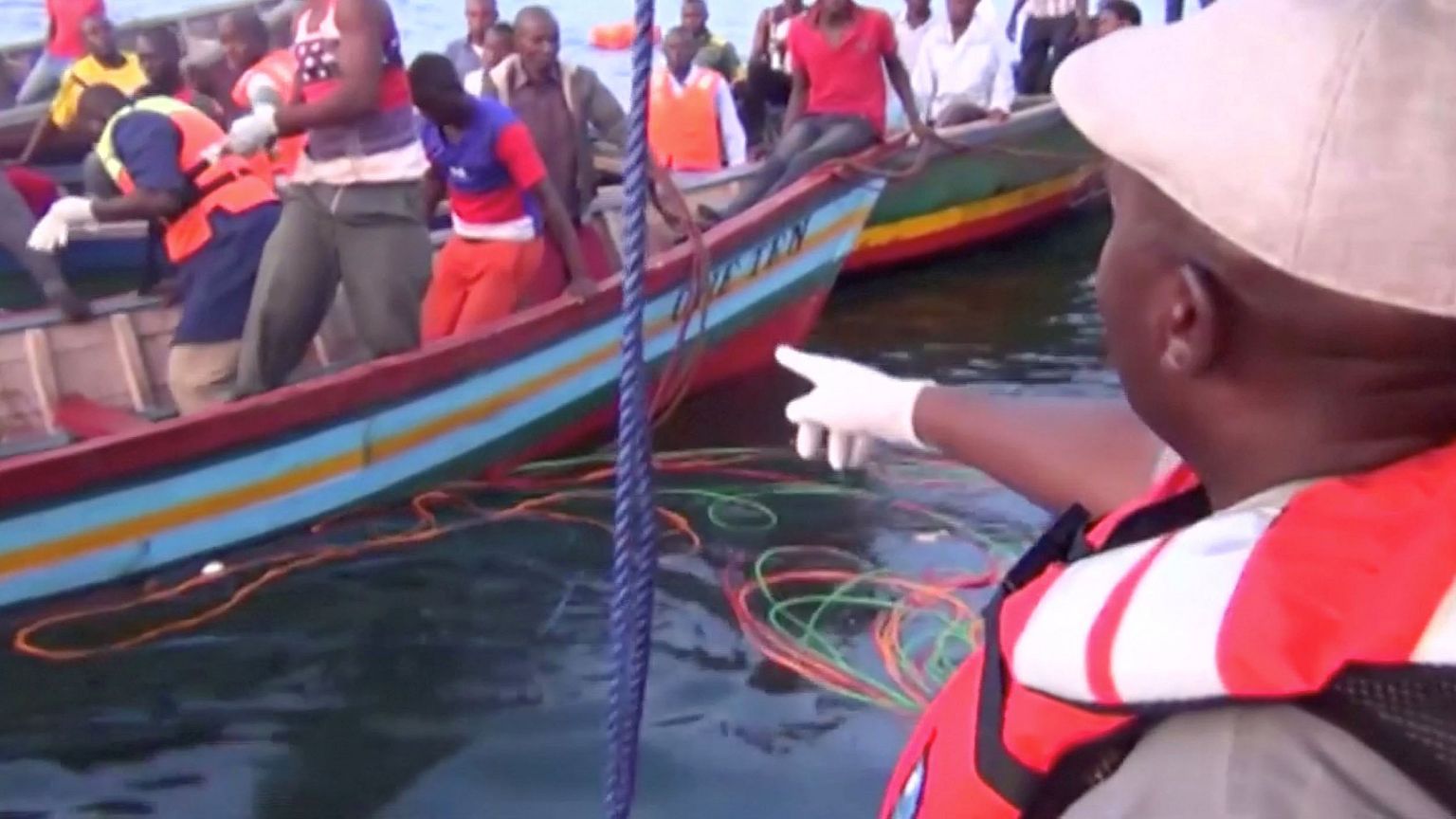 Image: Rescue workers are seen at the scene where a ferry overturned in Lak
