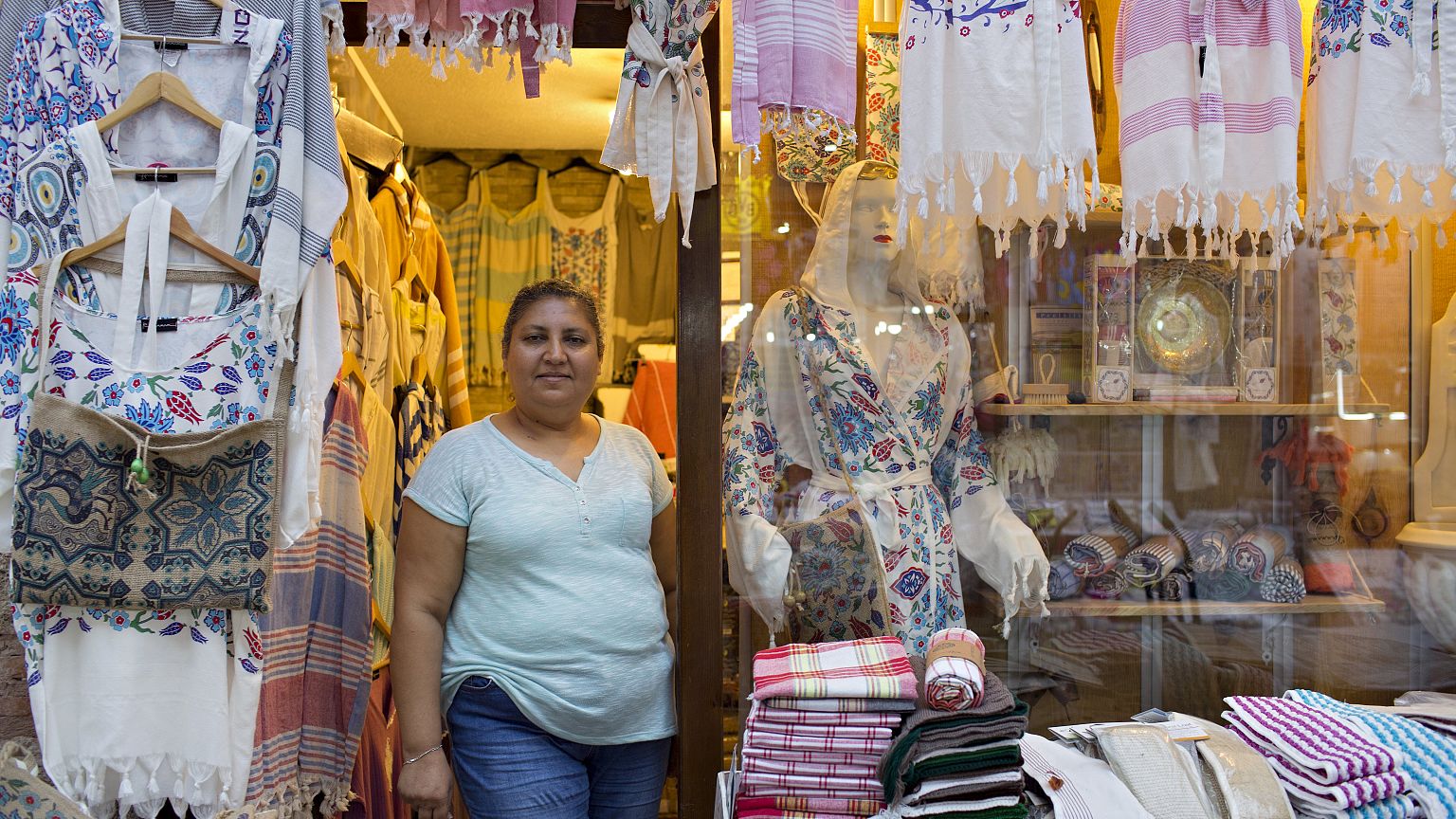 Image: Pembe Cavdar waits for customers at her Bursa clothing store