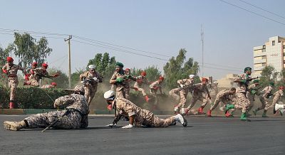 Iranian soldiers run for cover during a terrorist attack that occurred during Saturday\'s military parade.