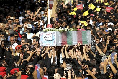 Mourners carry a casket during a mass funeral Monday for those who died in the Ahvaz attack.