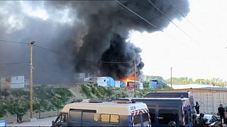 Afghan and Sudanese migrants battle in Calais camp