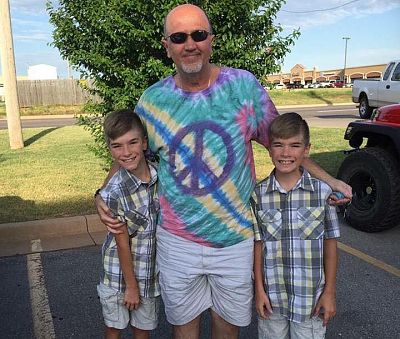 Austyn, left, and Tyler, right, with their grandfather, Jerry Greenough.