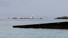Image: People are evacuated from an Air Niugini plane which crashed in the 