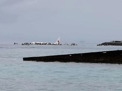 People are evacuated from an Air Niugini plane which crashed in the waters in Weno, Chuuk, Micronesia, on September 28, 2018 in this picture obtained from social media.