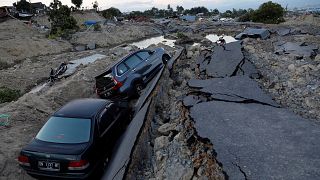 Image: Cars are trapped in sinking ground after an earthquake hit at Balaro